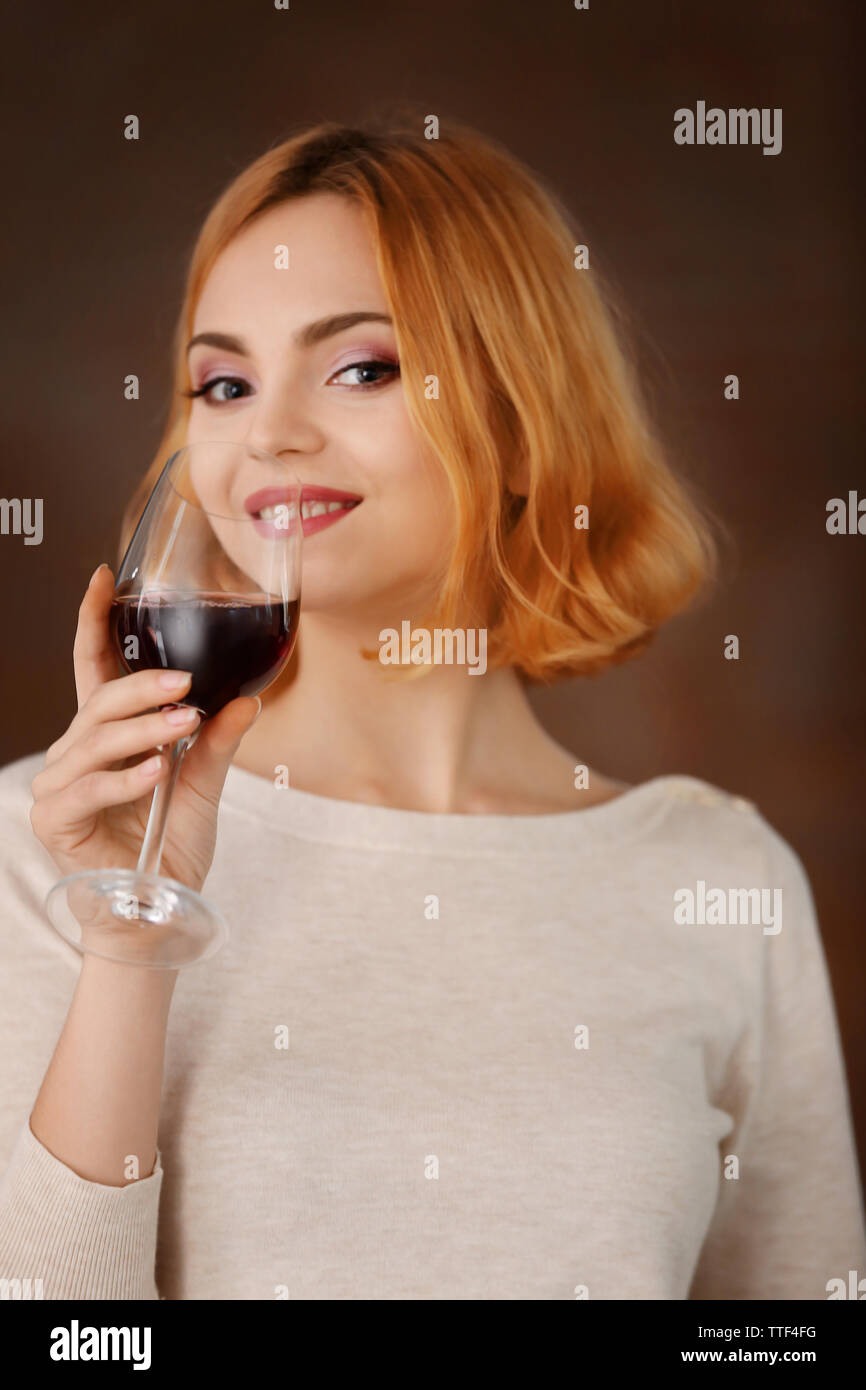 Young woman with glass of red wine on blurred background Stock Photo ...