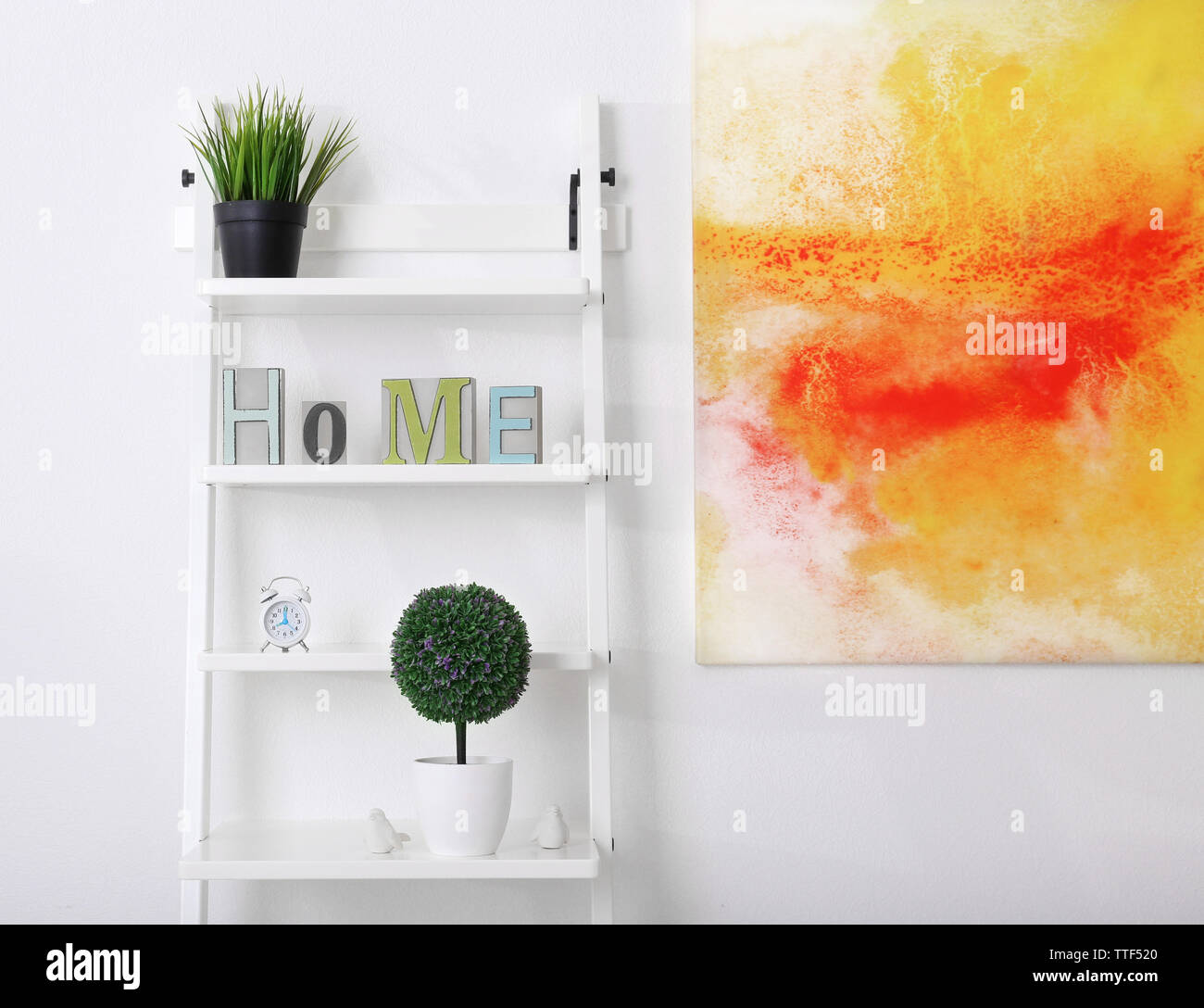 White bookcase against wall with bright picture in the room Stock Photo Alamy