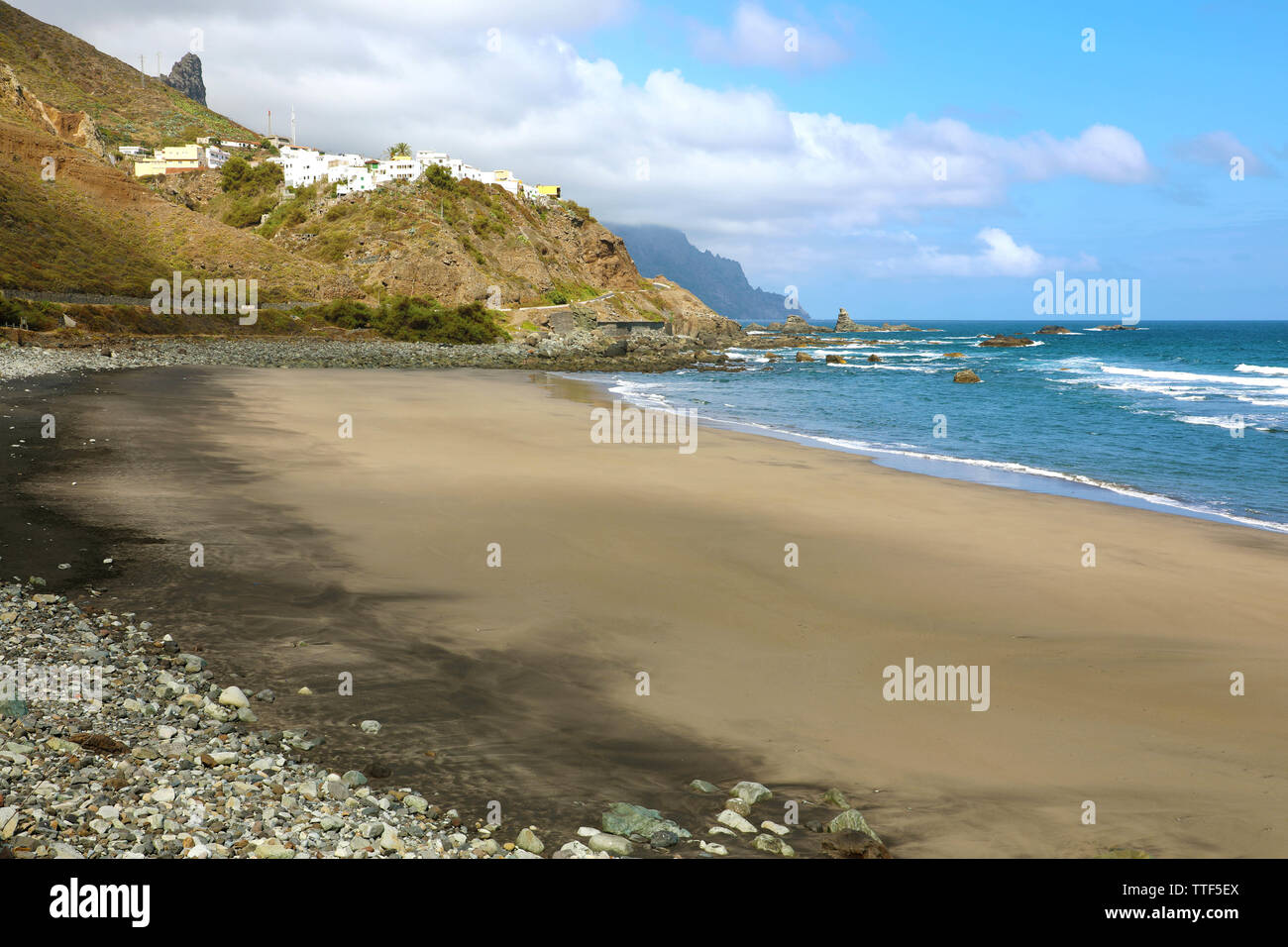 Playa de Almaciga beautiful beach with black sand with the village of Almaciga on the hill, Tenerife, Spain Stock Photo