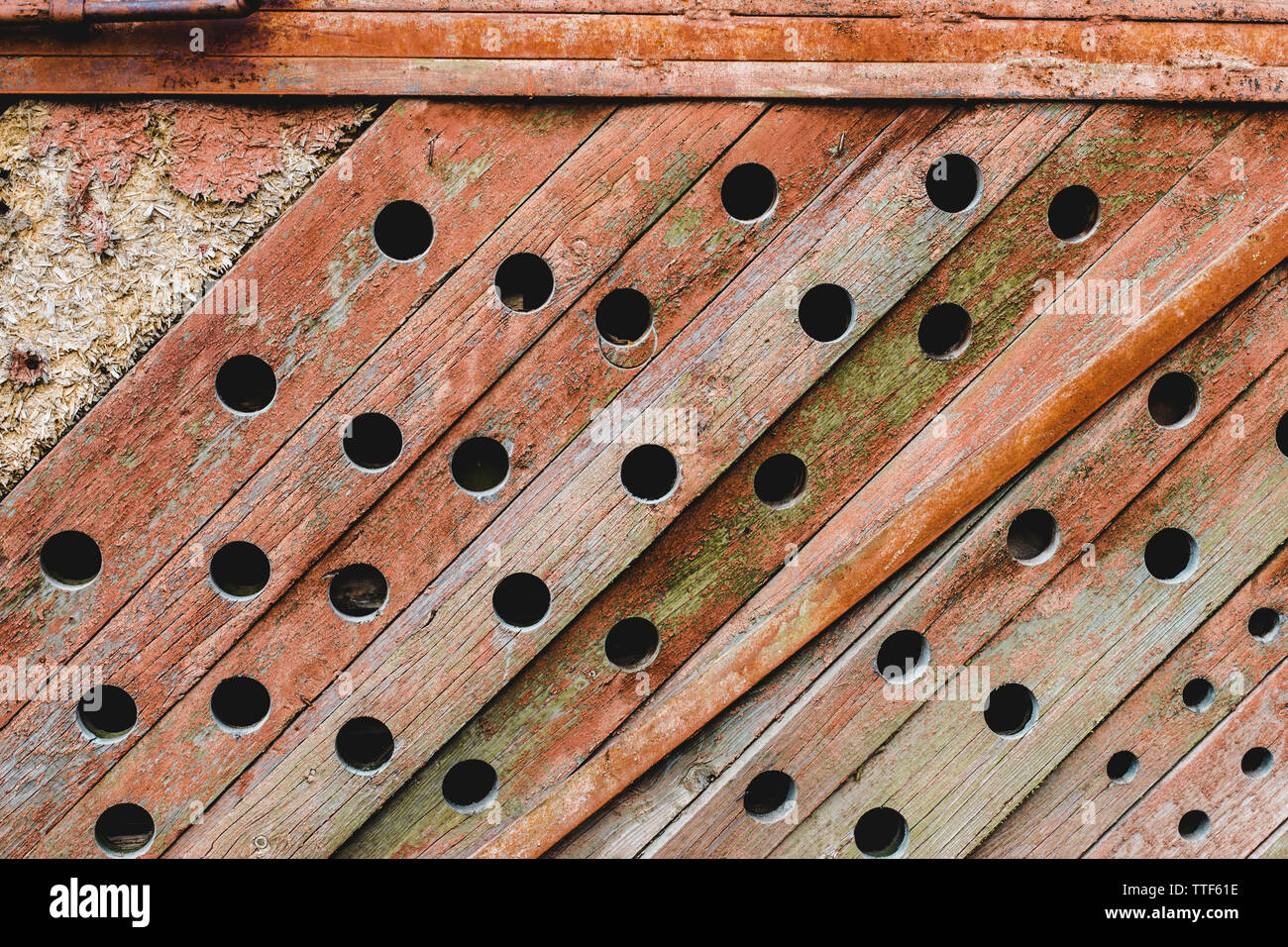 Grunge, wooden, ancient texture. Old background with wavy paint, orange paint and round holes Stock Photo