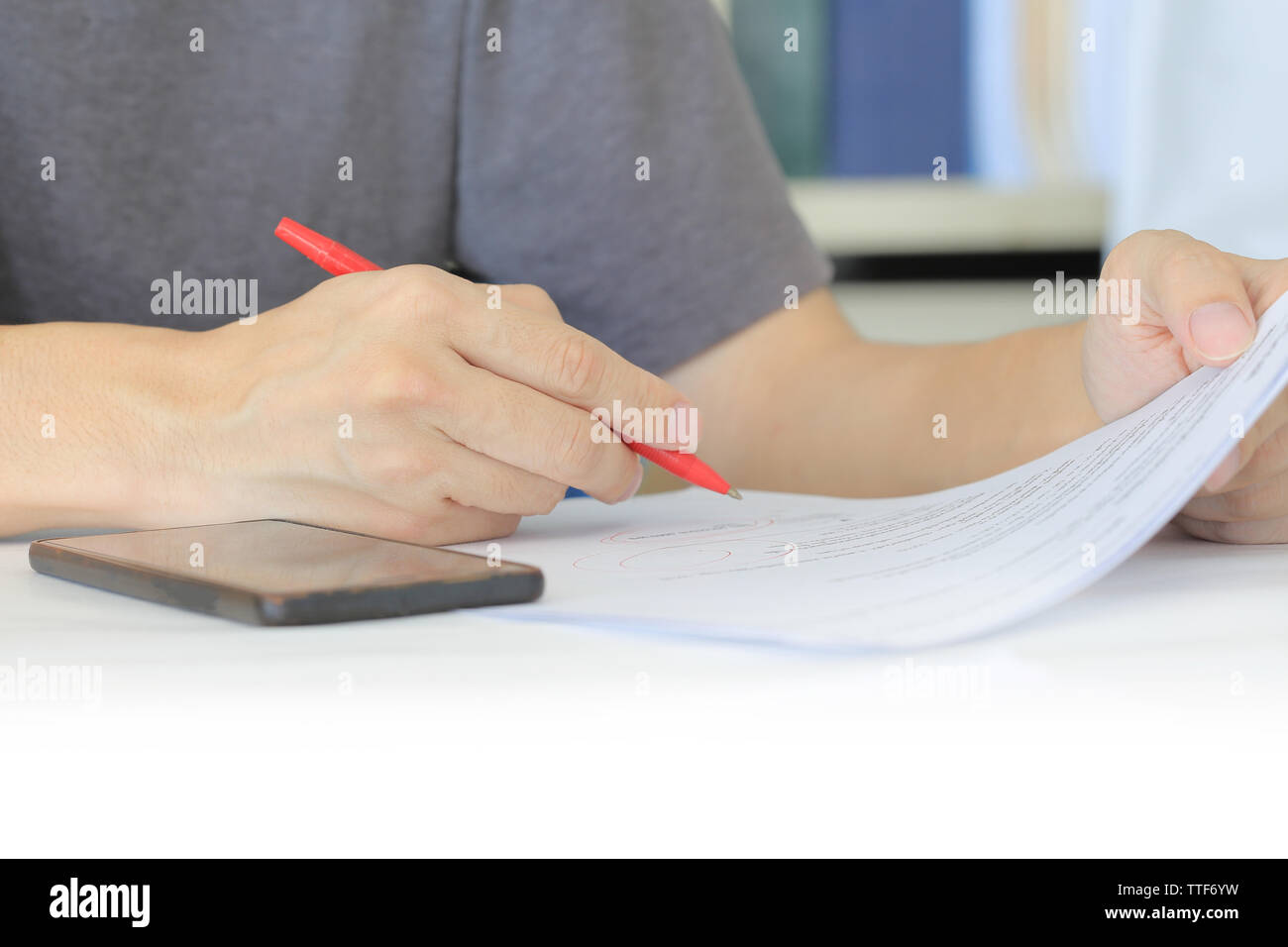 Closeup human hand checking work on a paper. freelance man writing with ...