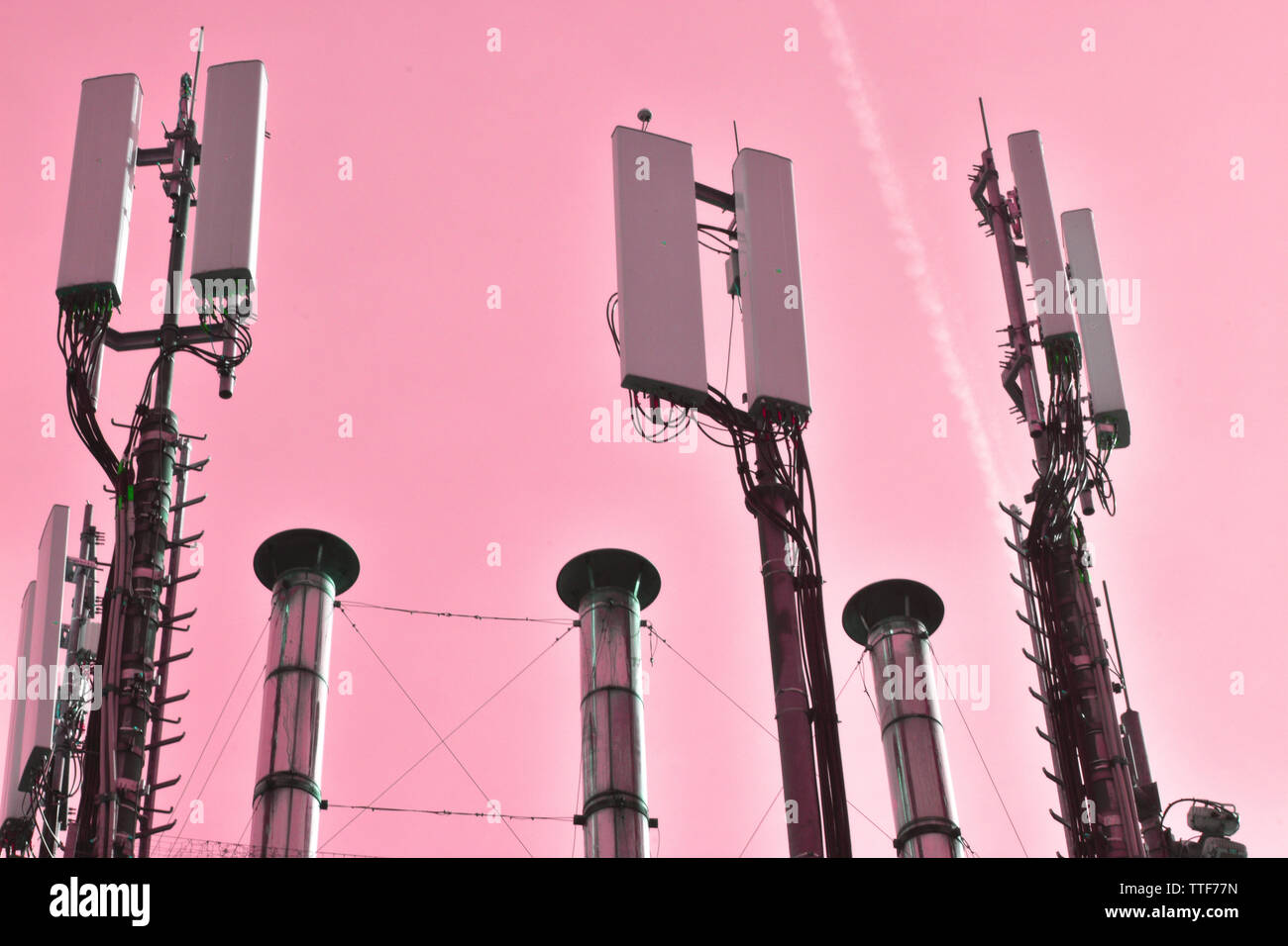 industrial, metalic chimney and radio structures, set on pink clear
