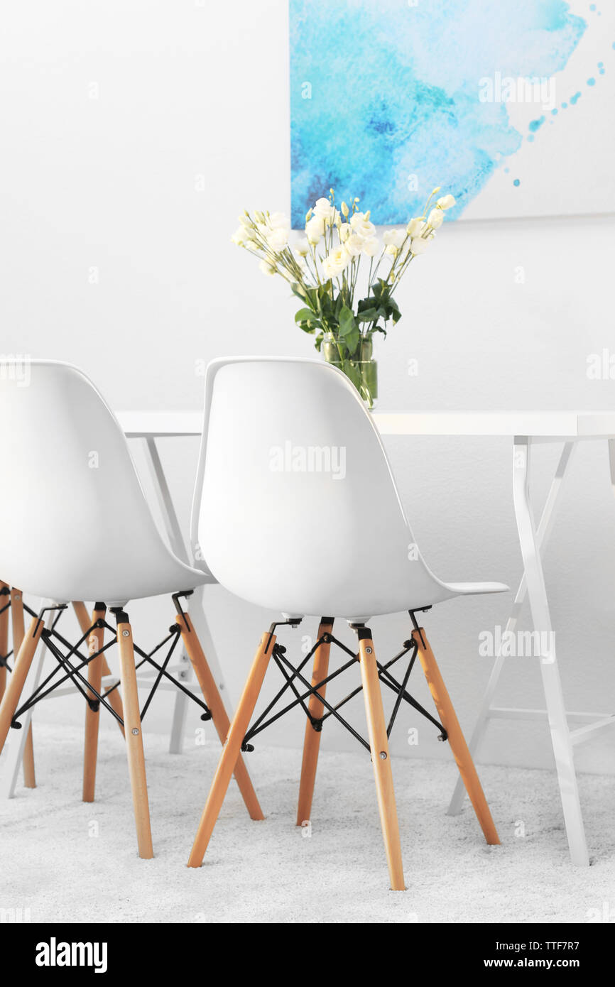 Modern Dining Room White Chairs And Table With Bouquet Of Flowers Abstract Picture On The Wall Stock Photo Alamy