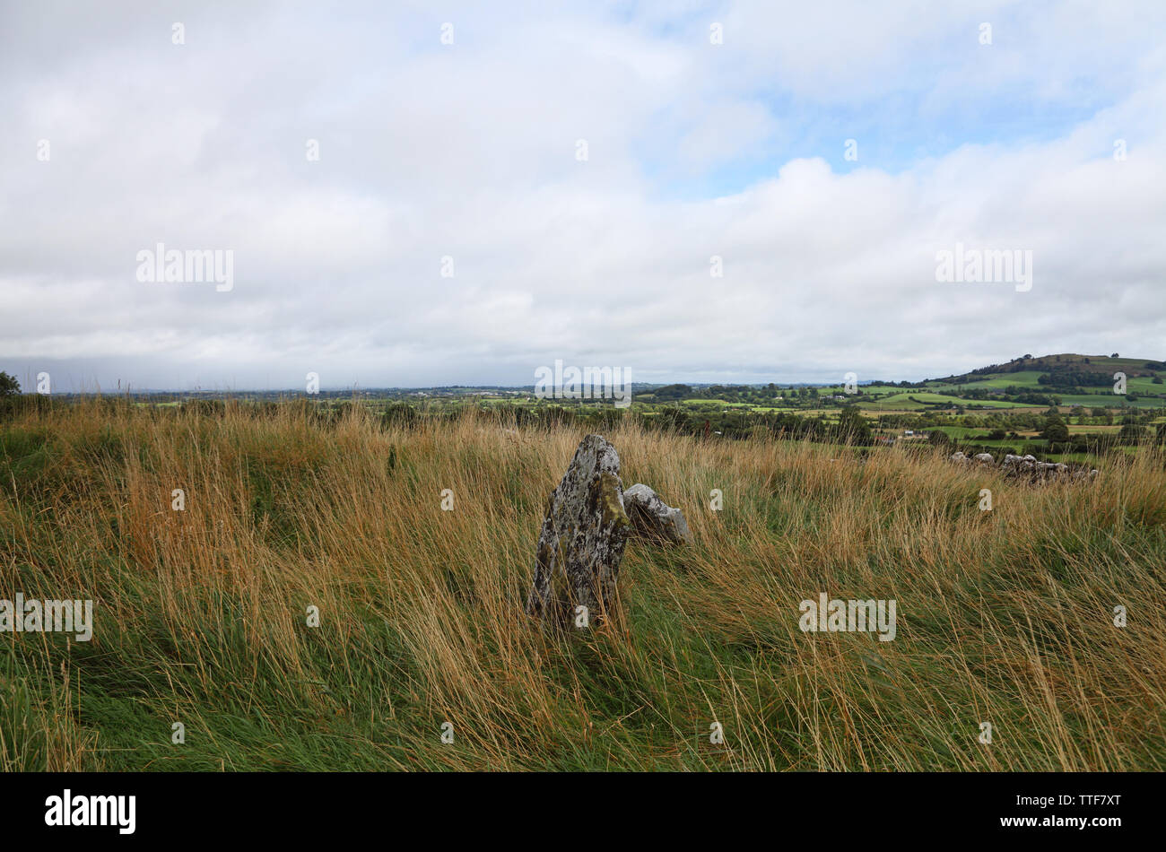 Gravestone by medieval church and tower ruins and ancient graveyard