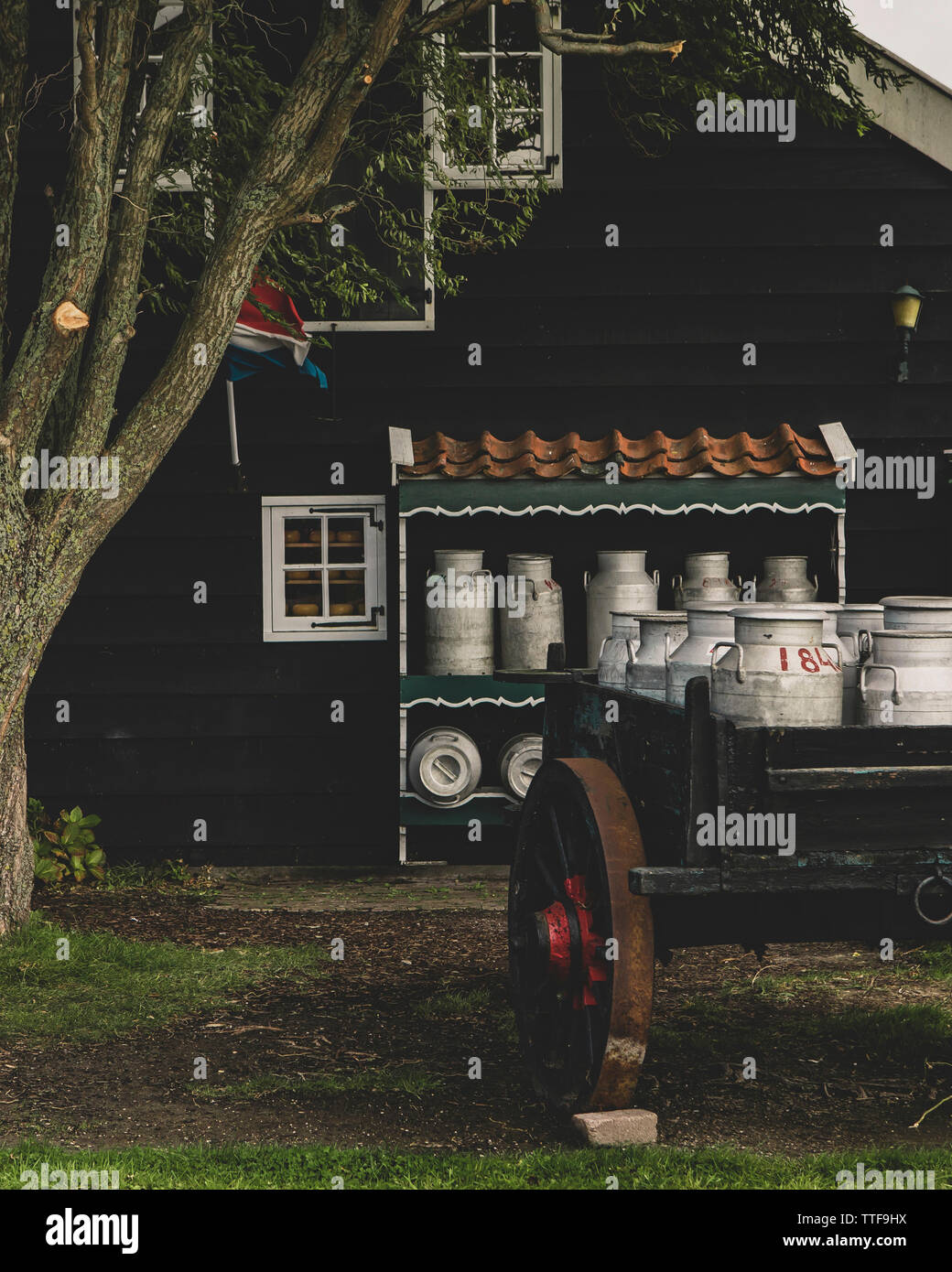Milk cans on wooden traditional cart, in open-air museum Zaanse Schans Stock Photo
