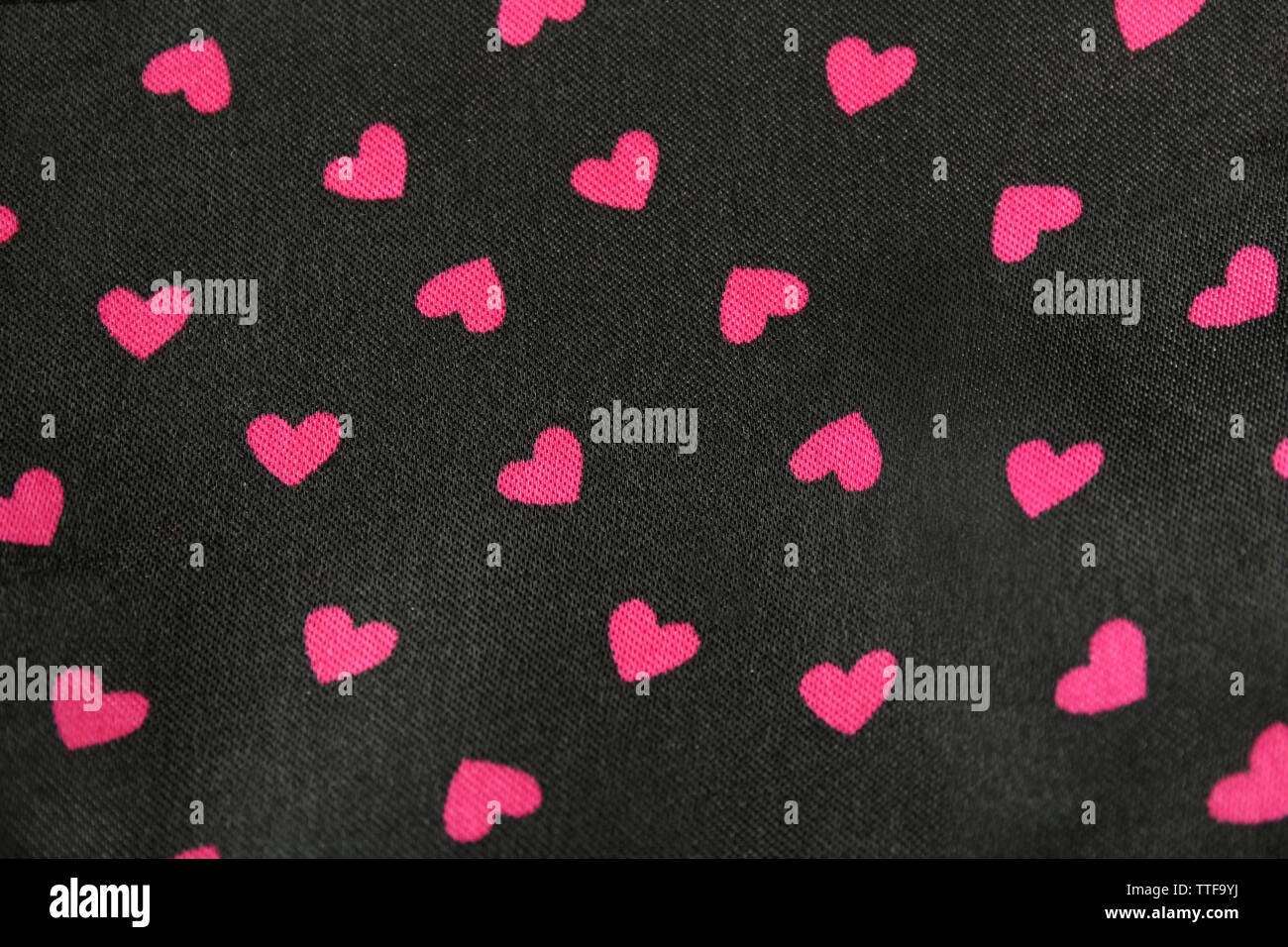 Pink hearts pattern on black background Stock Photo - Alamy