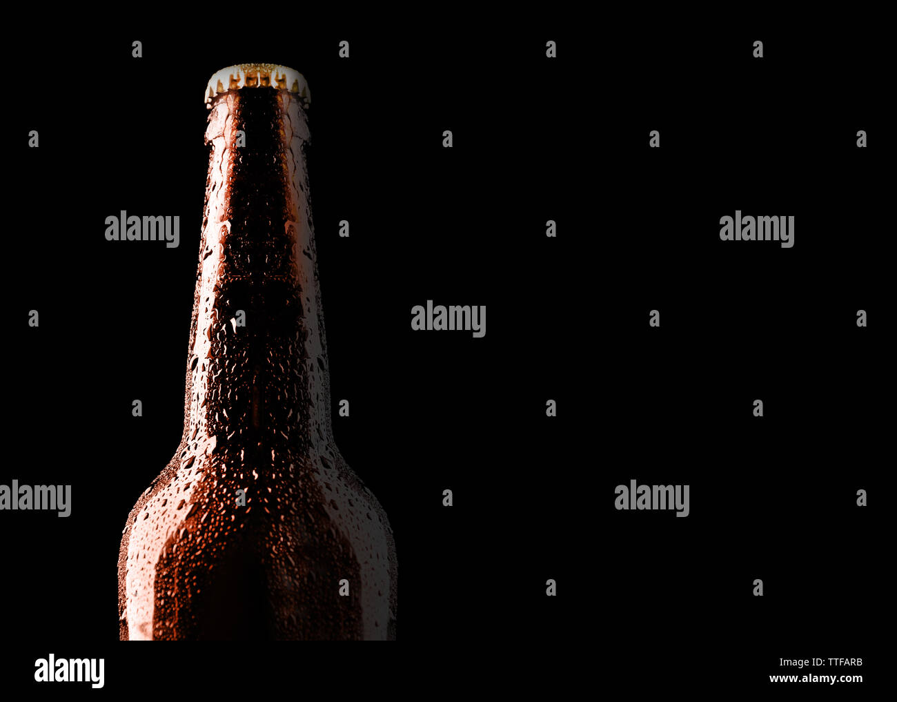 Glass bottle of beer on black background Stock Photo - Alamy