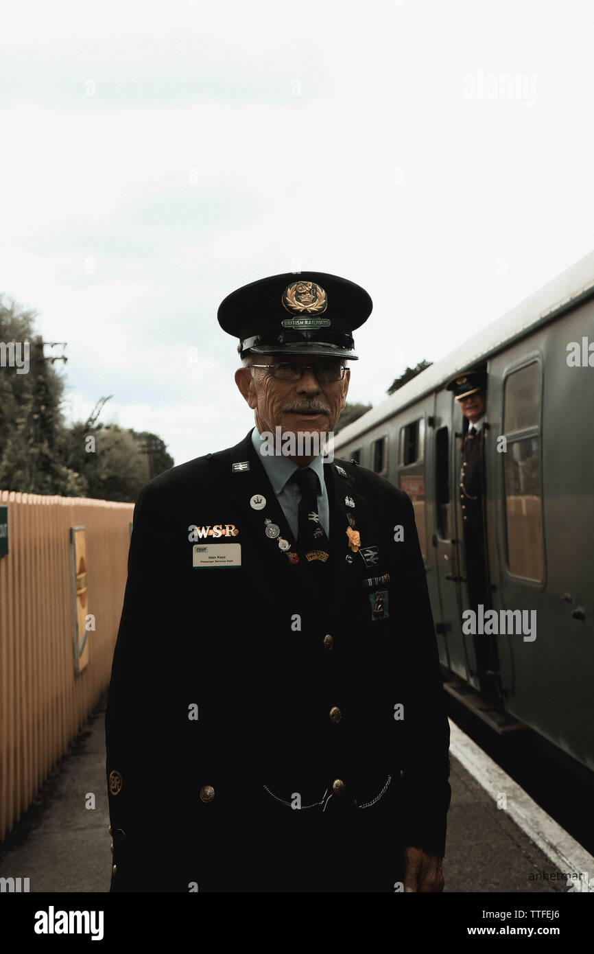 Portrait of an elderly employee of the English railway on the backgrou Stock Photo