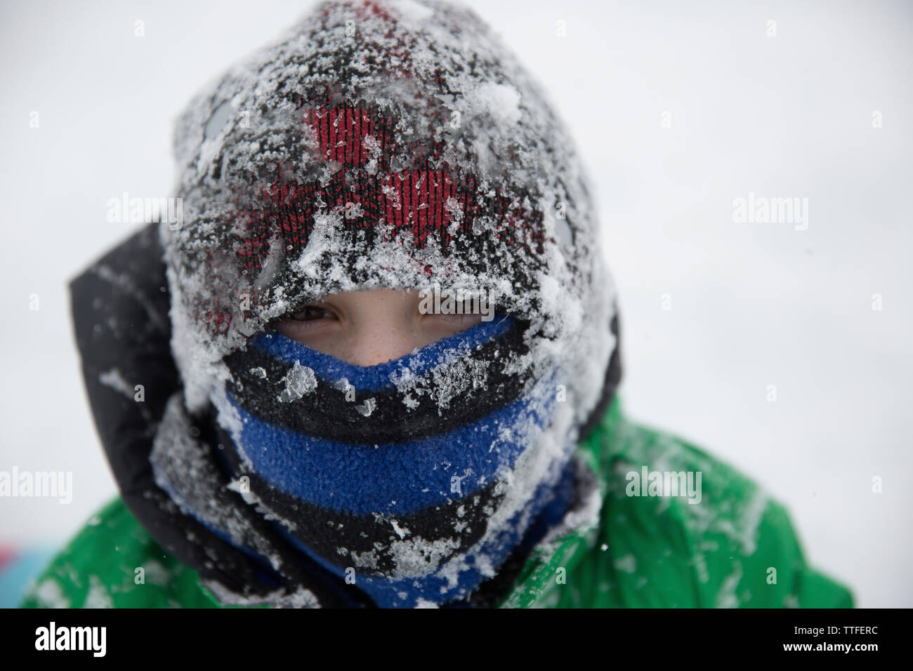 Portrait of teenage boy wearing frozen warm clothing during winter Stock Photo