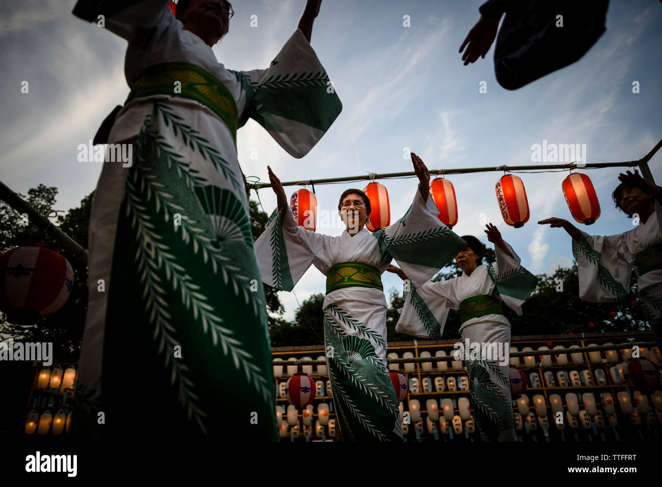 Low angle view of women dancing during traditional festival at Obon Stock Photo