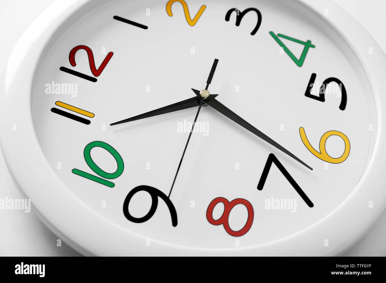 Round wall clock with colorful figures, close up Stock Photo Alamy