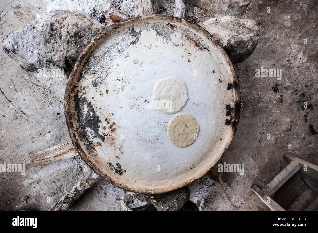 Nutritious handmade corn tortilla cooked on a metal griddle on a gas stove  in a Guatemalan home Stock Photo - Alamy