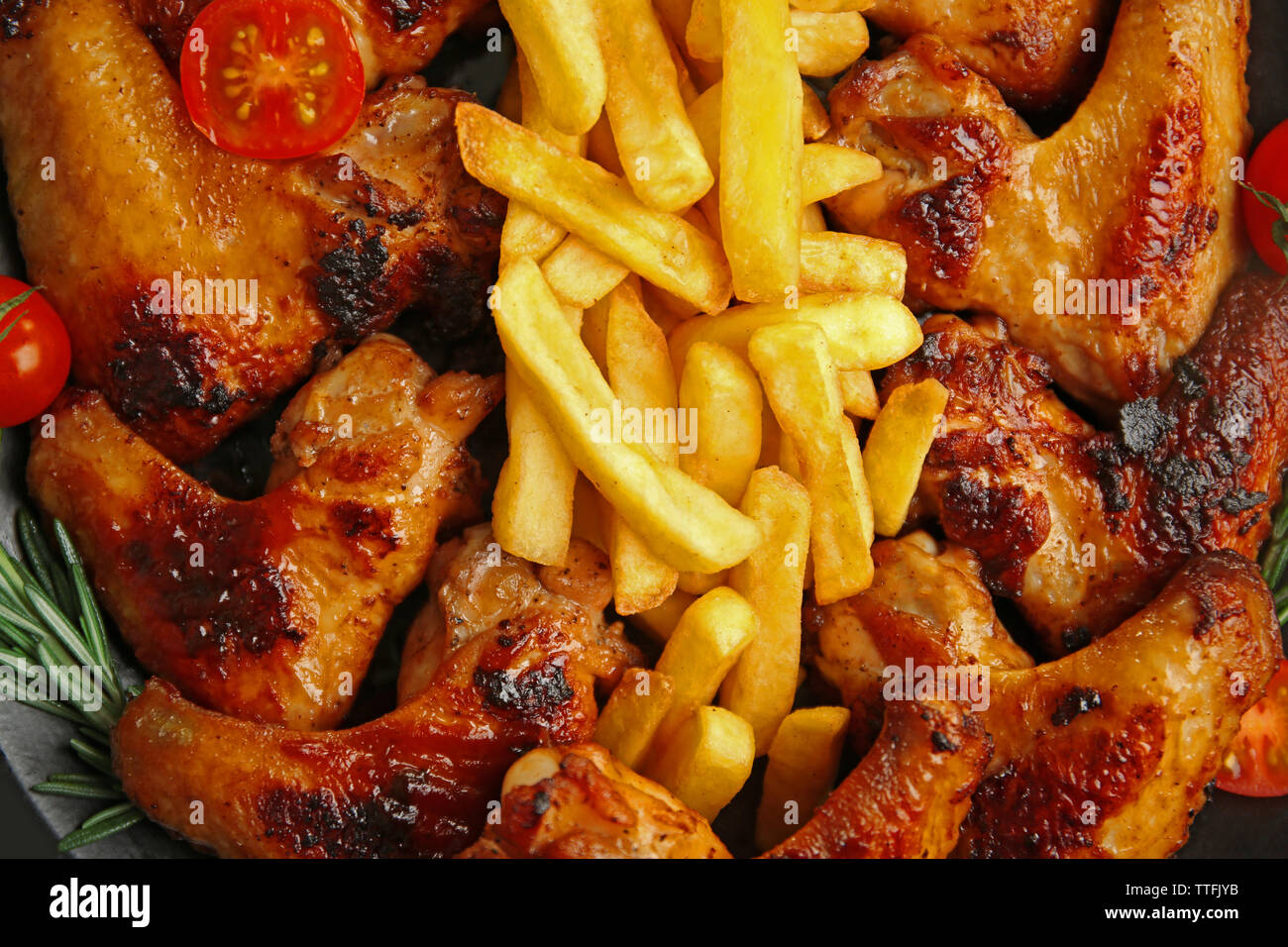 Grilled chicken wings with French fries background Stock Photo Alamy