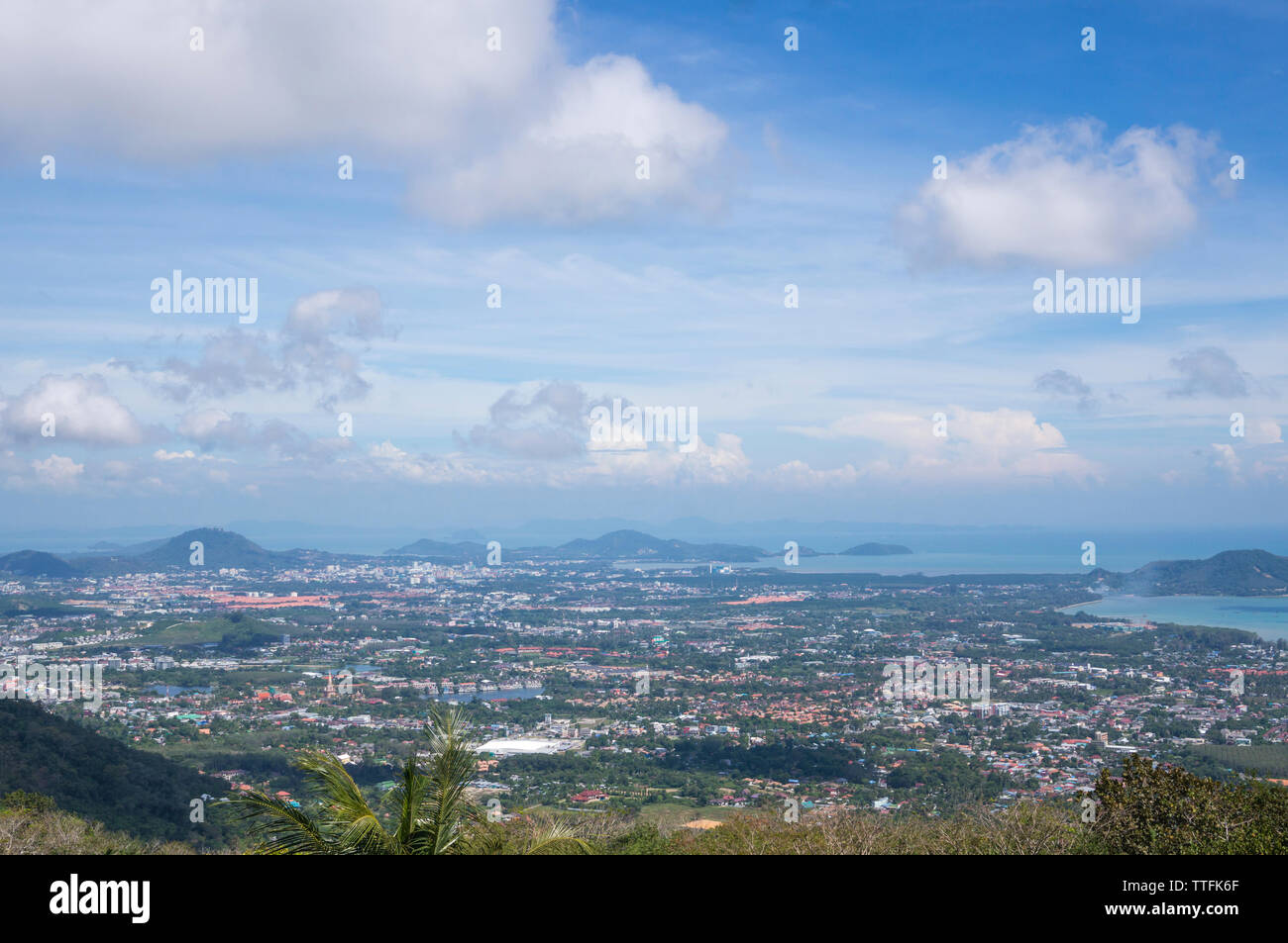 Aerial view of landscape against cloudy sky during sunny day Stock Photo