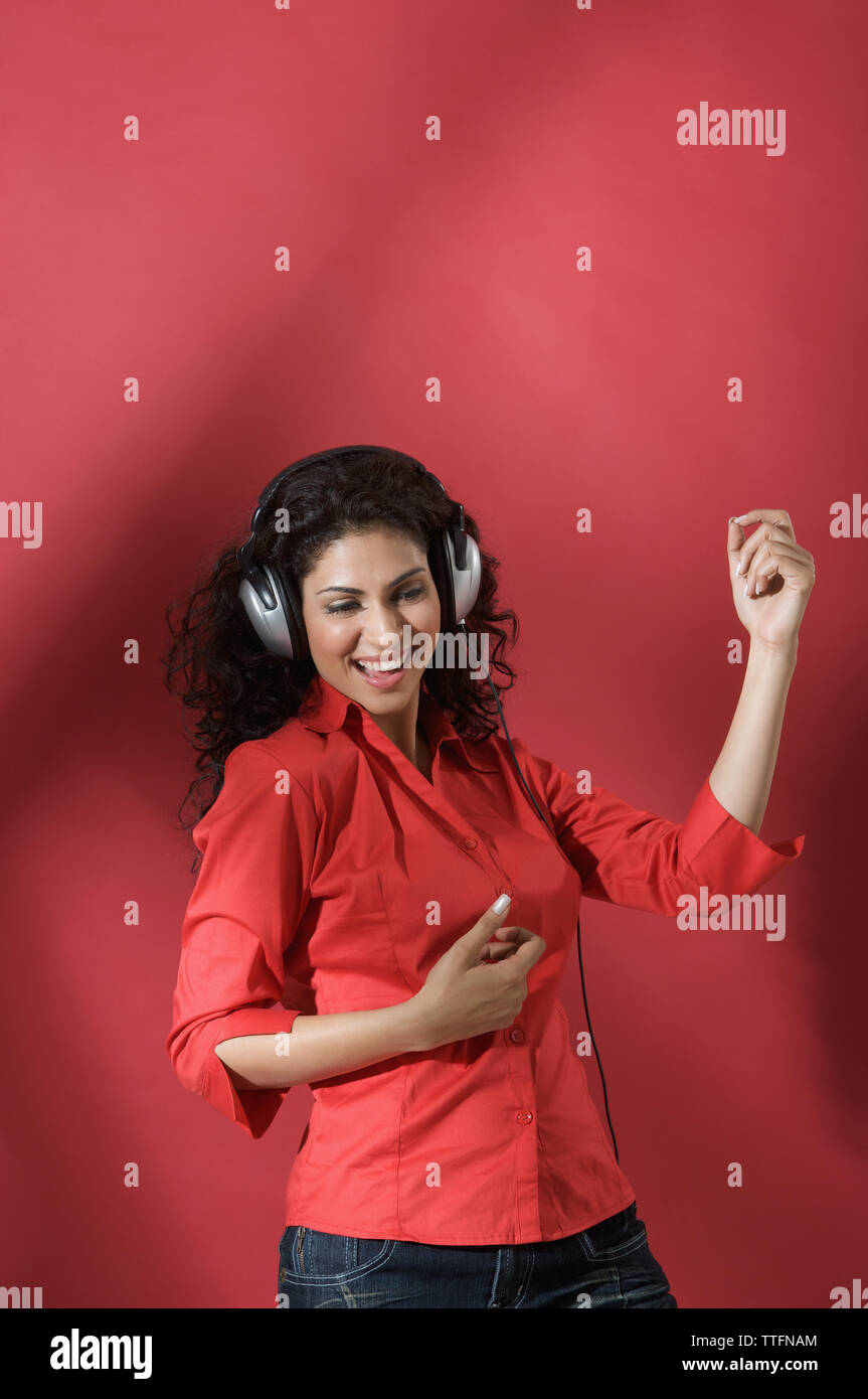 Woman listening to music with headphones and dancing Stock Photo - Alamy