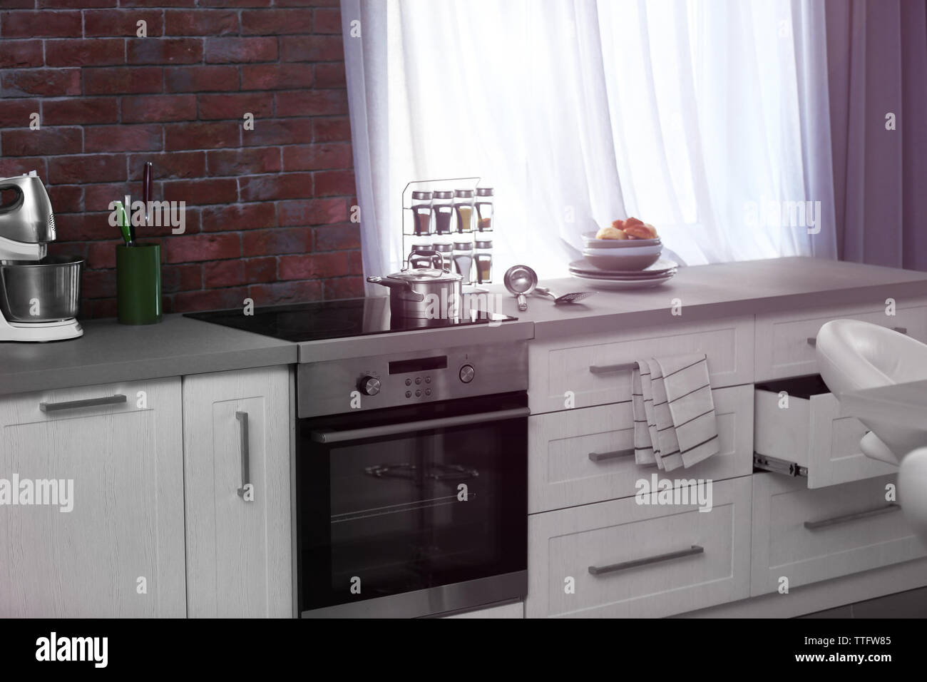 Modern kitchen interior with white furniture and electric stove Stock ...