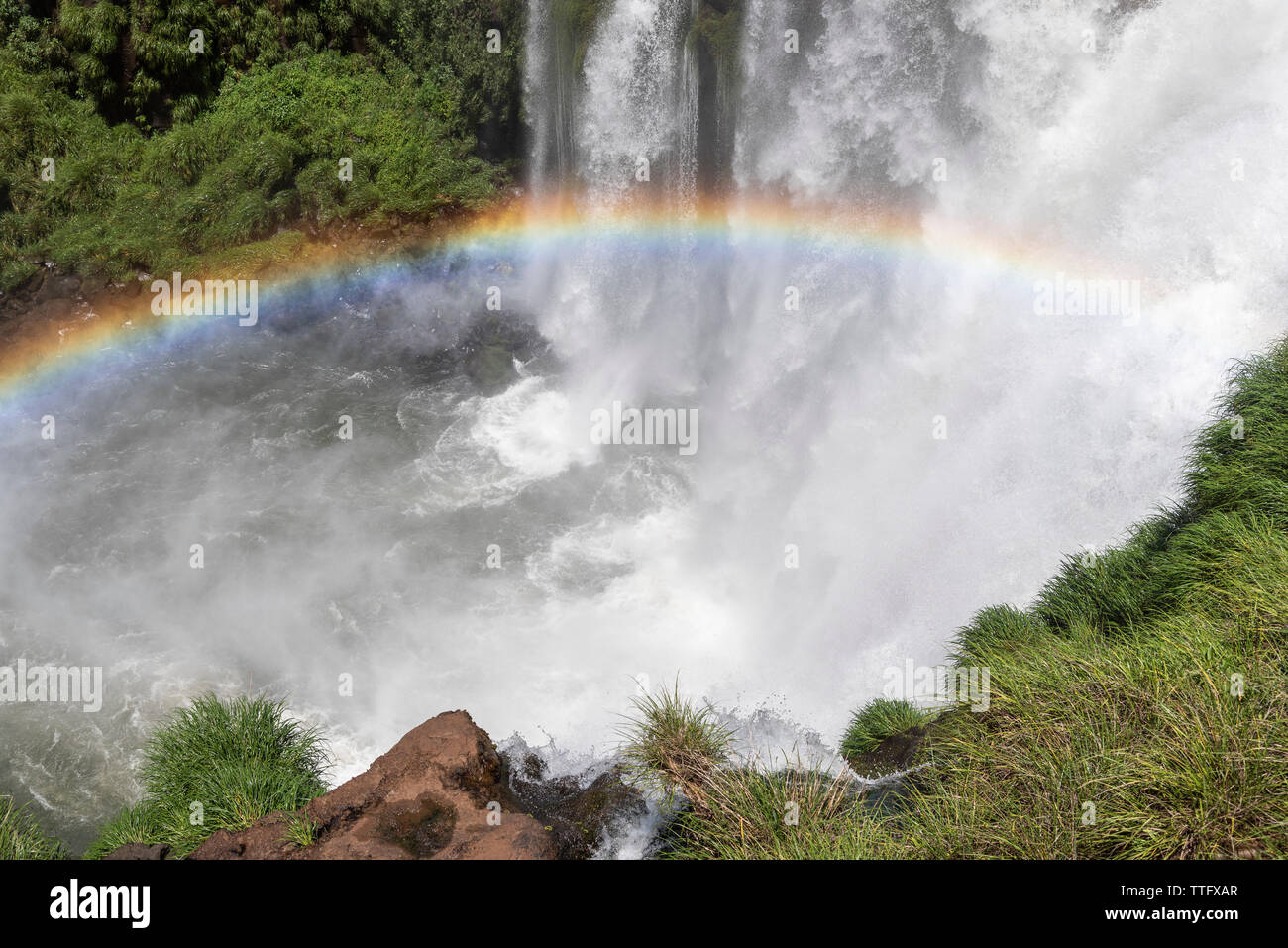 Beautiful landscape of big waterfall and rainbow on green rainforest Stock Photo