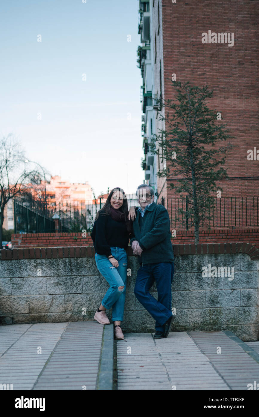 Father and daughter of adult age smile on the street Stock Photo