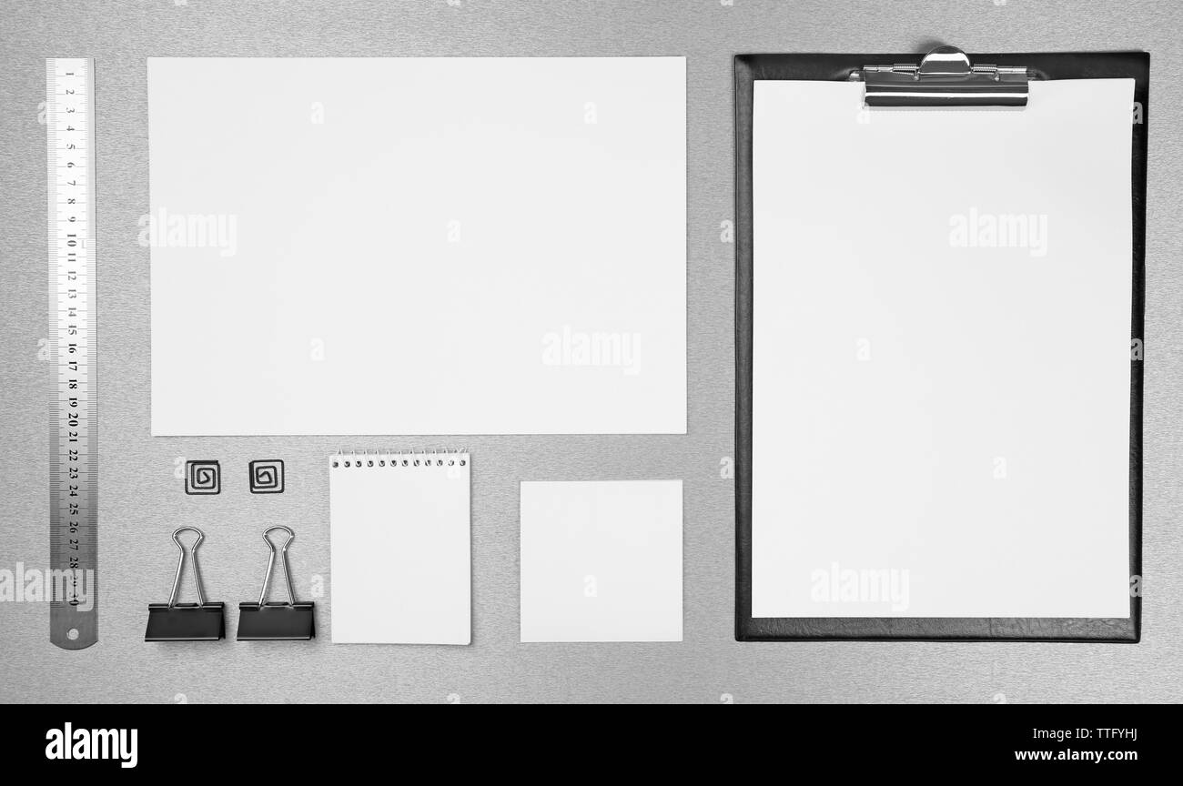 Office set with white sheets of paper, notebook and stationery on grey background Stock Photo