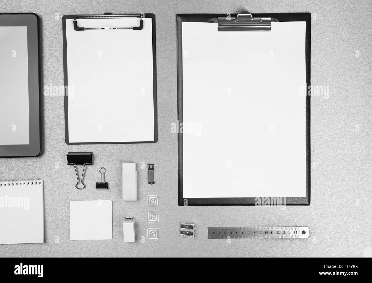 Office set with white sheets of paper, tablet and stationery on grey background Stock Photo Alamy