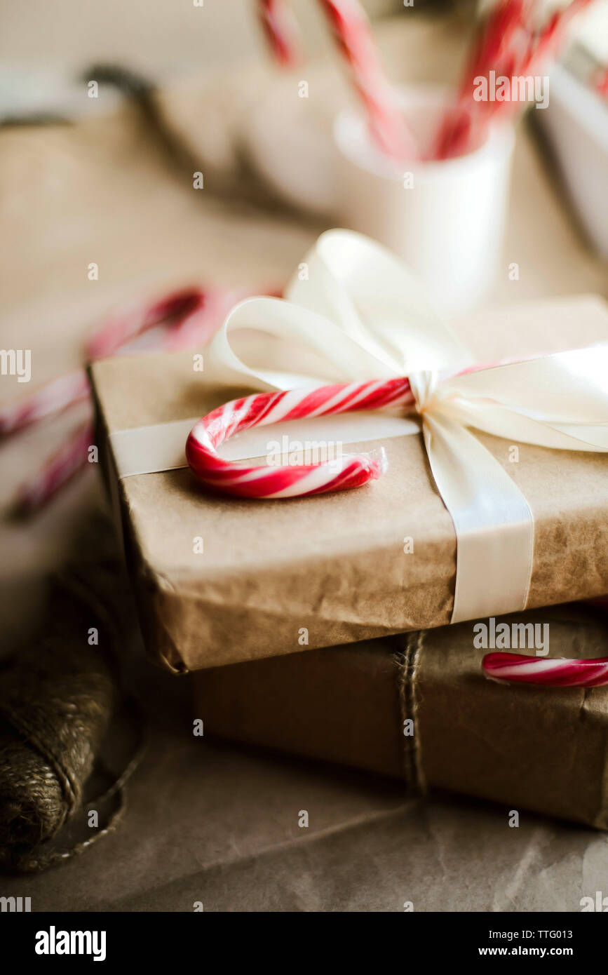 christmas present with candy canes on wooden table Stock Photo