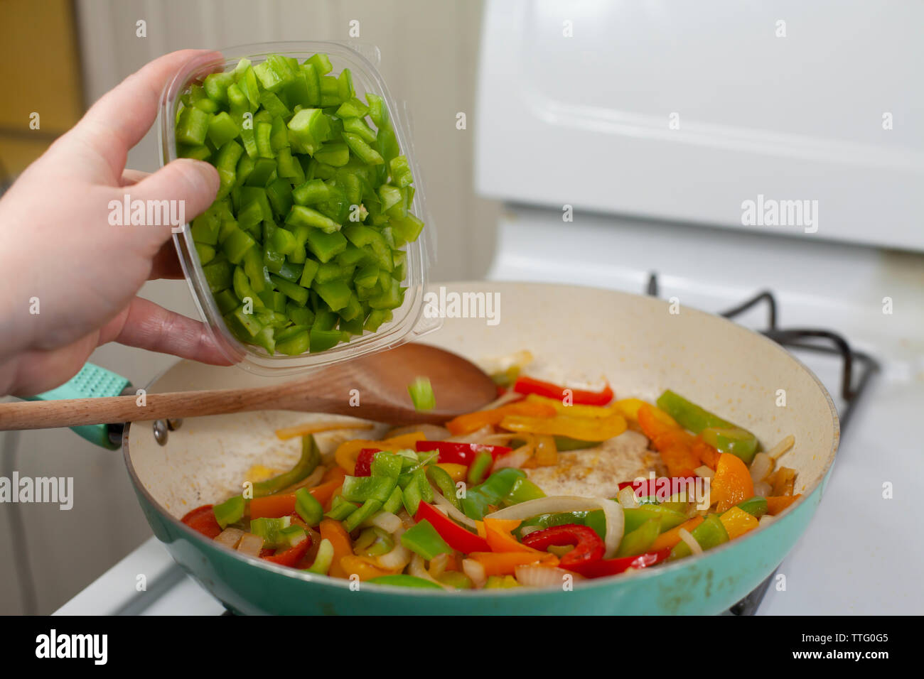 Green, Red and Pouring Green Bell Peppers into a Pan Filled with Red