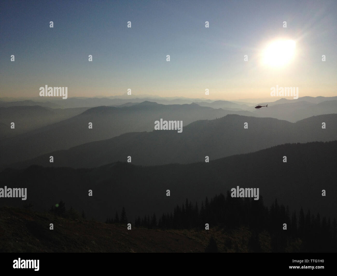 Helicopter in sky on sunny day Stock Photo - Alamy