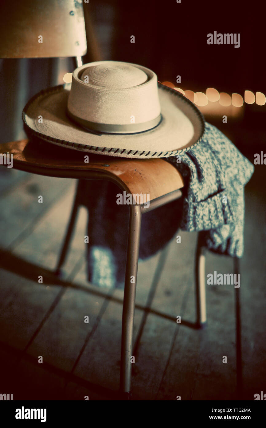 Close-up of hat and sweater on chair Stock Photo