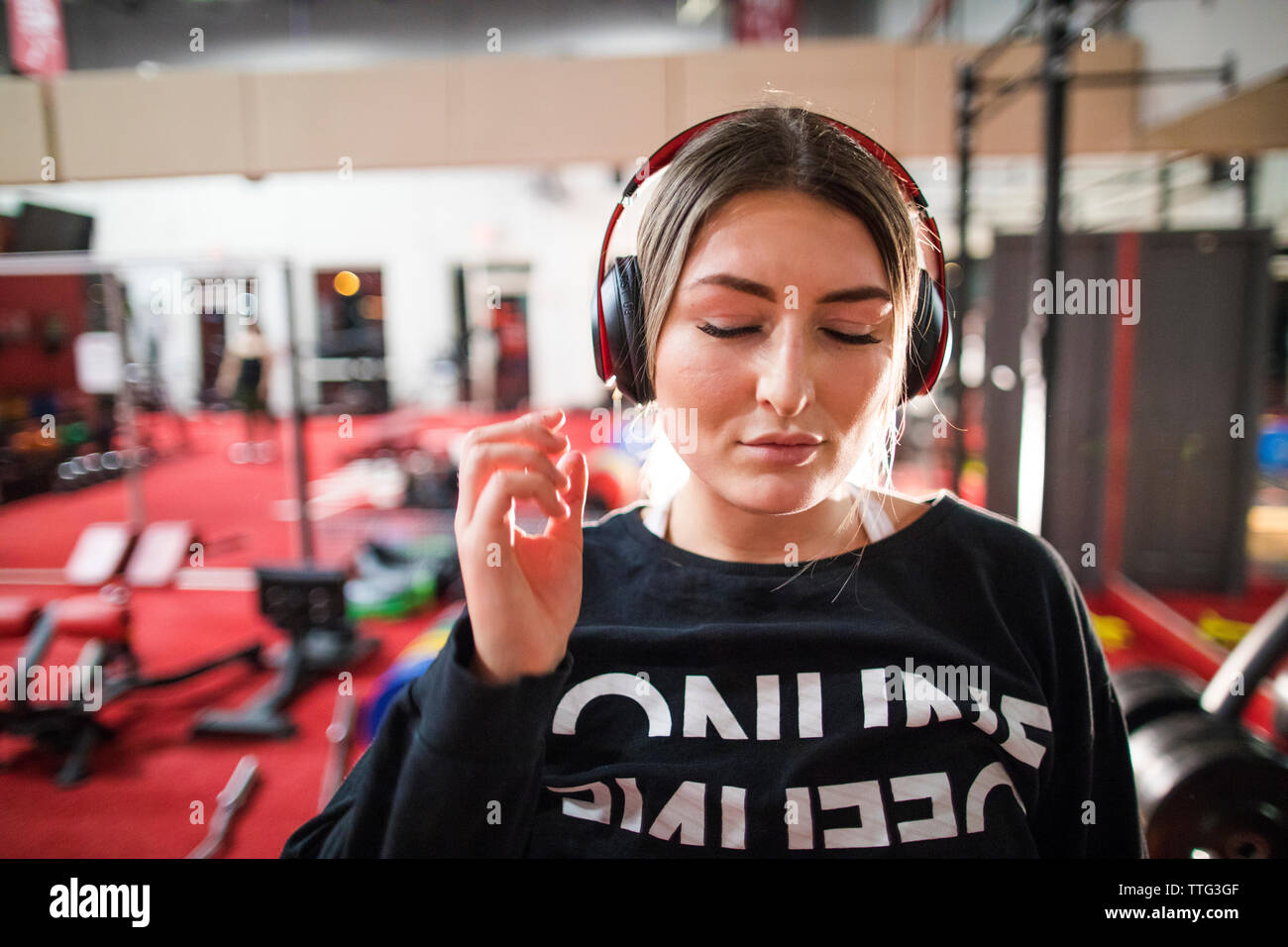 Attractive woman listening to music during a workout at the gym. Stock Photo