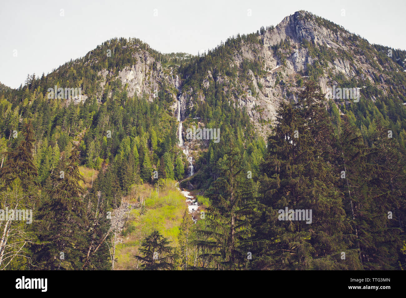 Low angle of Waterfall and steep mountains, British Columbia, Canada. Stock Photo