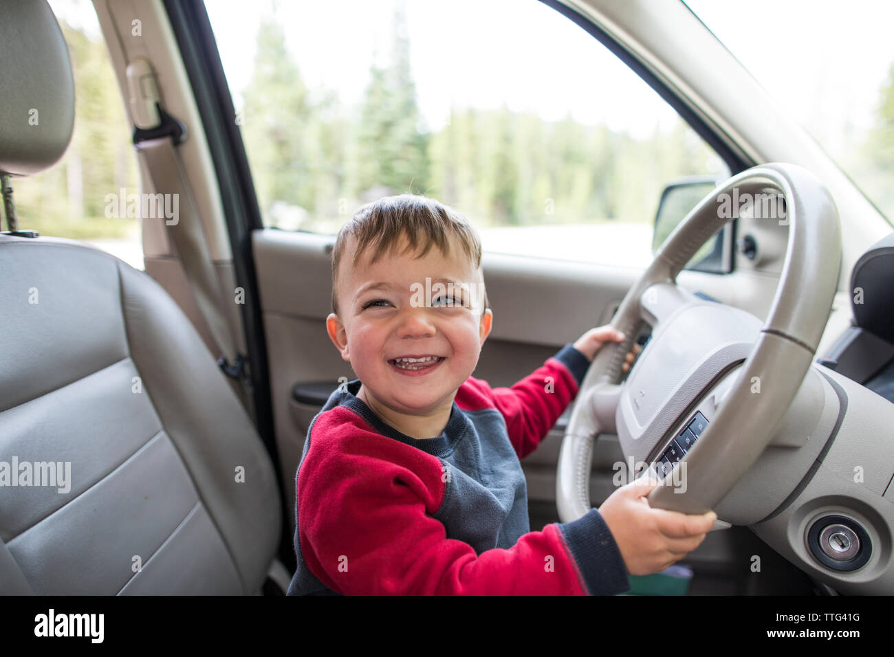Little boy pretending to drive car Stock Photo
