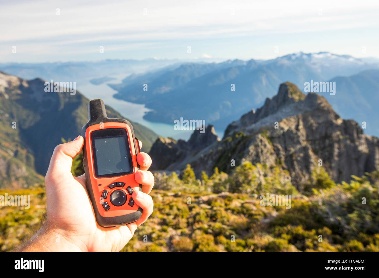 Hiker uses GPS device to navigate route, Douglas Peak, B.C. Stock Photo