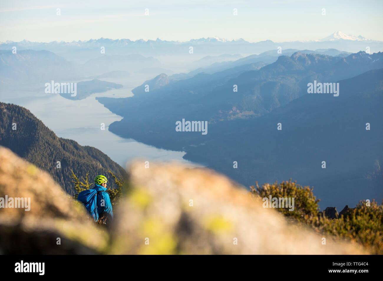 Climber looks down on Harrison Lake from Douglas Peak, B.C. Canada