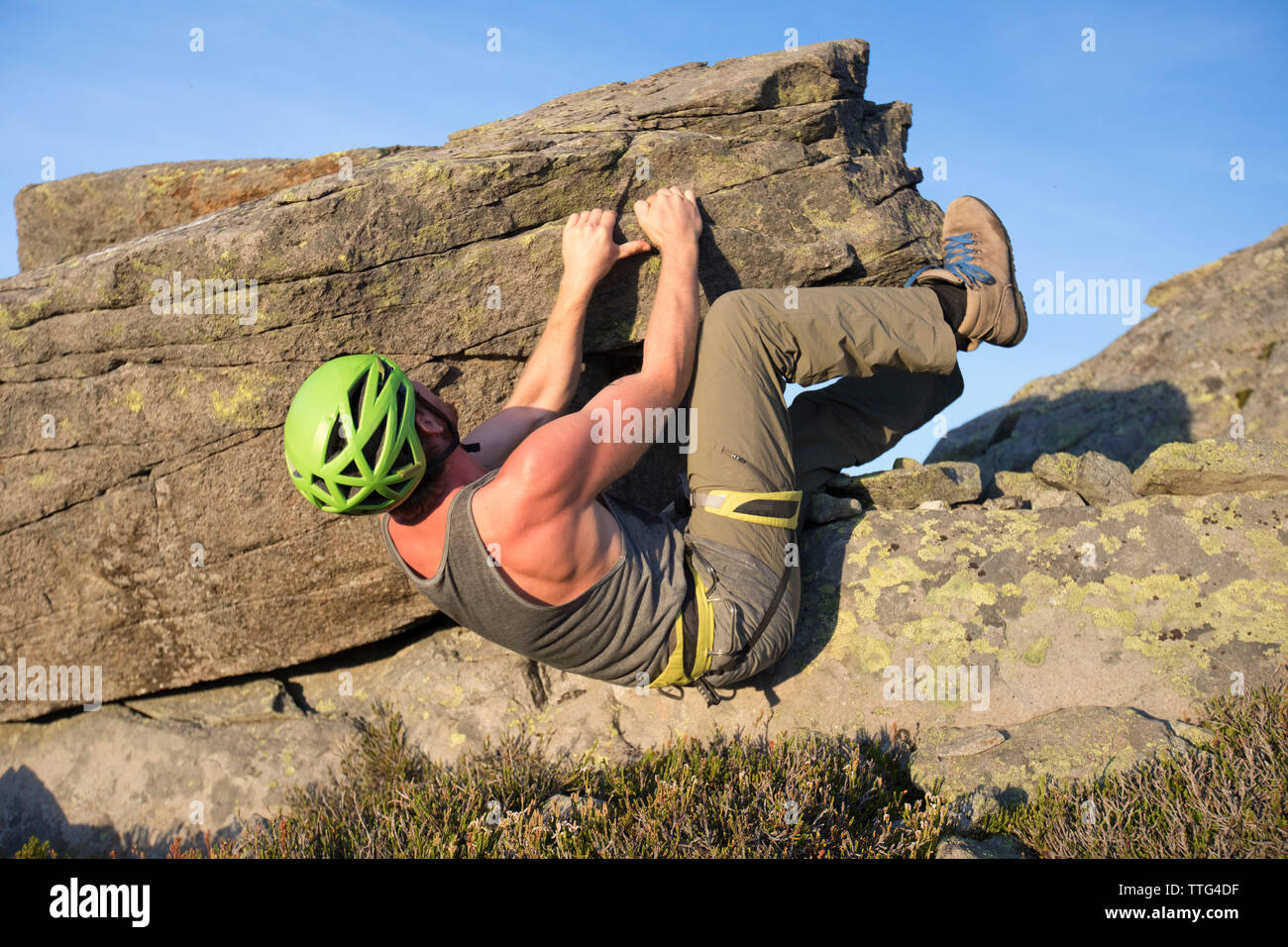 Low angle of man bouldering on rock in the Coast Mountain Range. Stock Photo