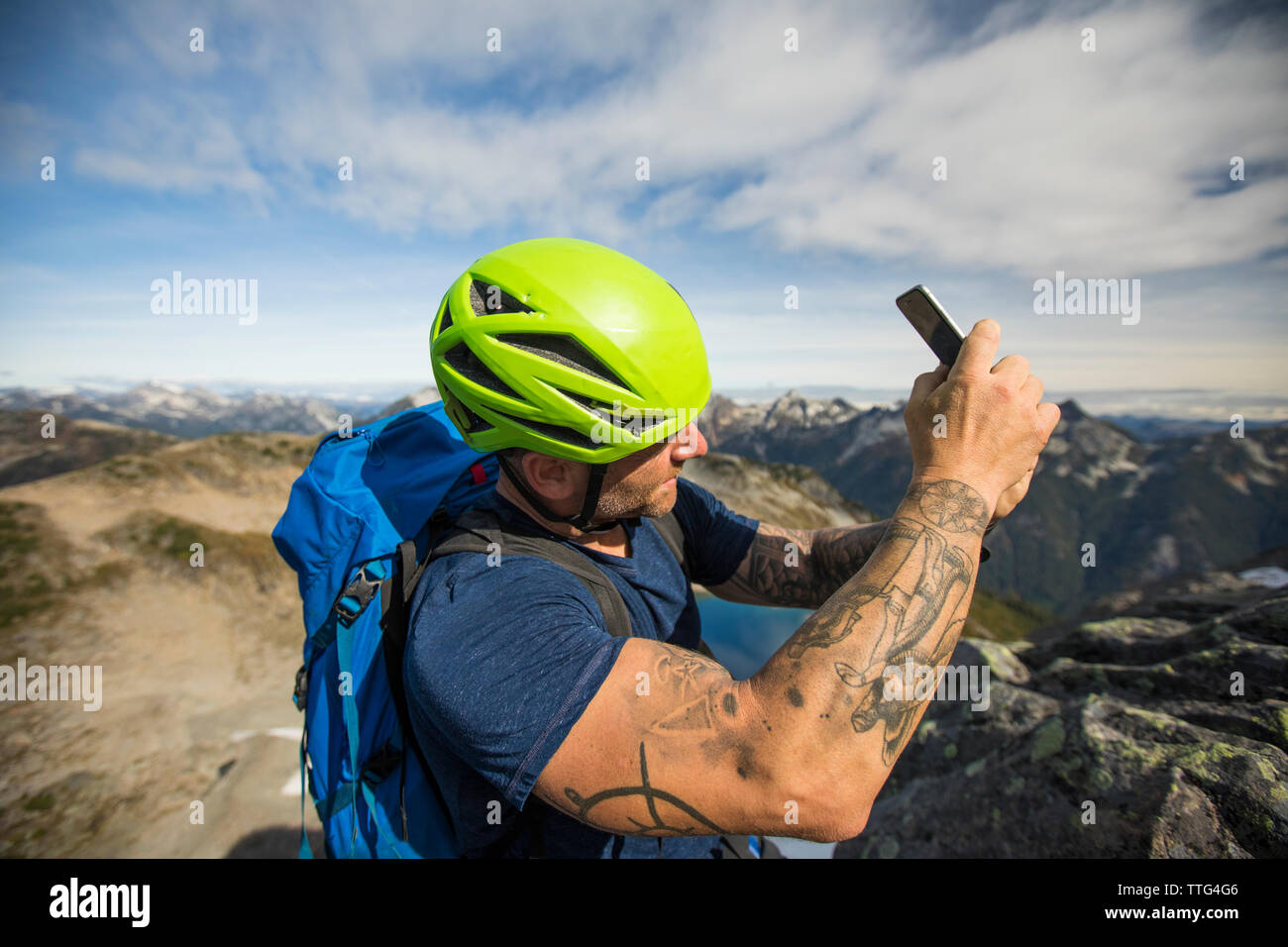Mountaineer takes photo with his smartphone. Stock Photo
