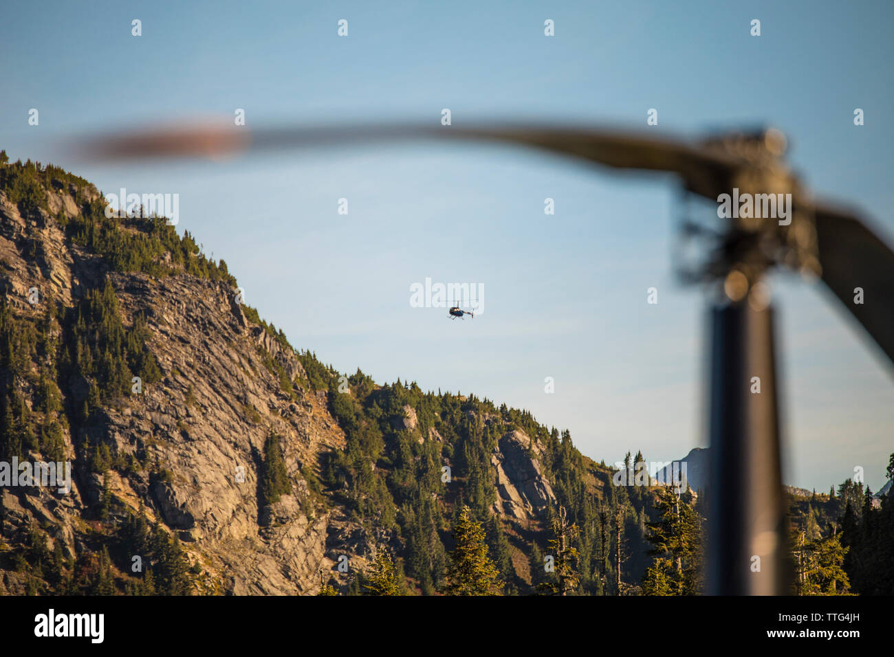 Helicopter flying over the Coast Mountain Range. Stock Photo
