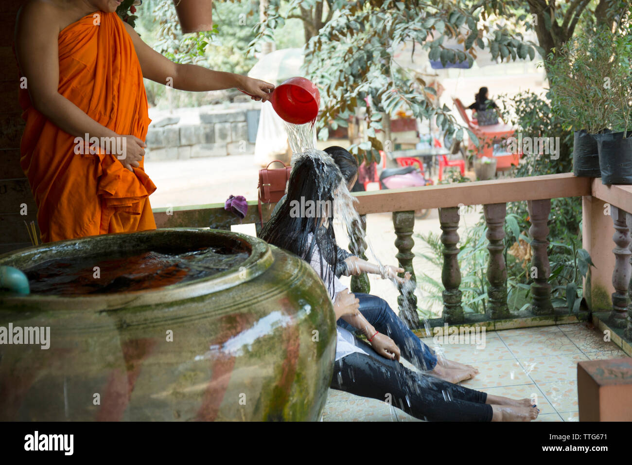 Two woman blessed by a buddhist monk in Cambodia Stock Photo