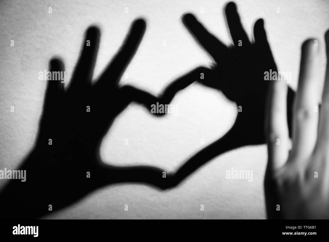 Hand shaped heart on light background Stock Photo