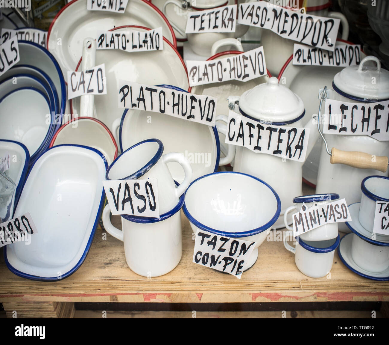 Old spanish shop offering enamel ware. Vintage white ware made f Stock