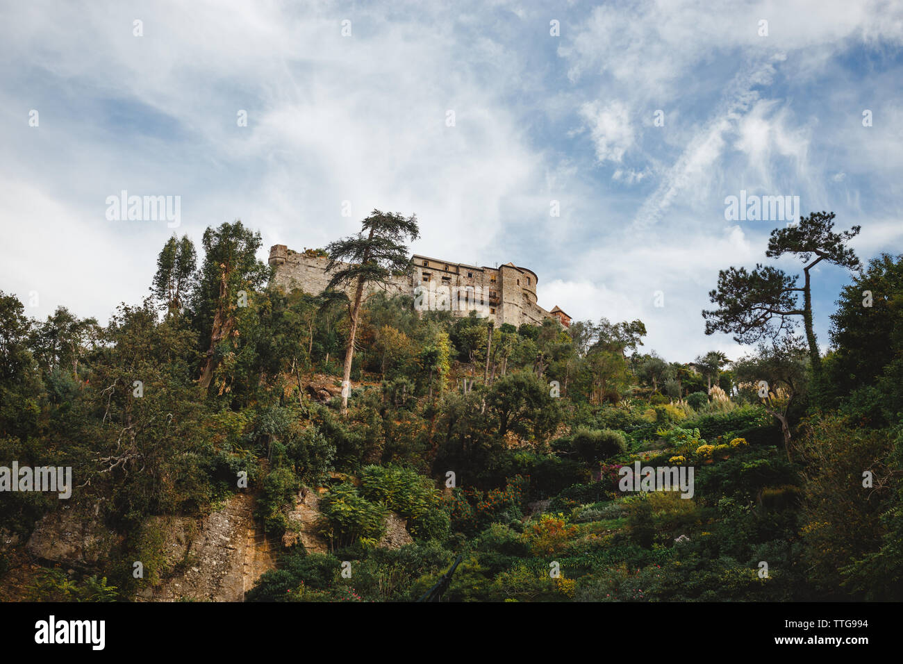 A stone dwelling atop a ridge under a summer sky Stock Photo