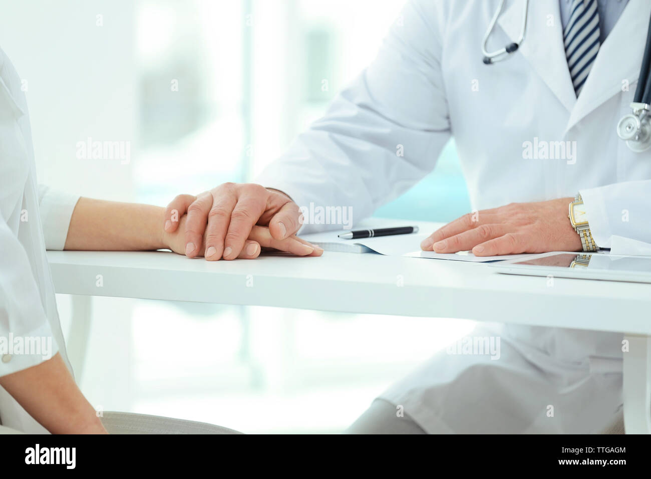 Doctor talking to patient on exam table hi-res stock photography and ...