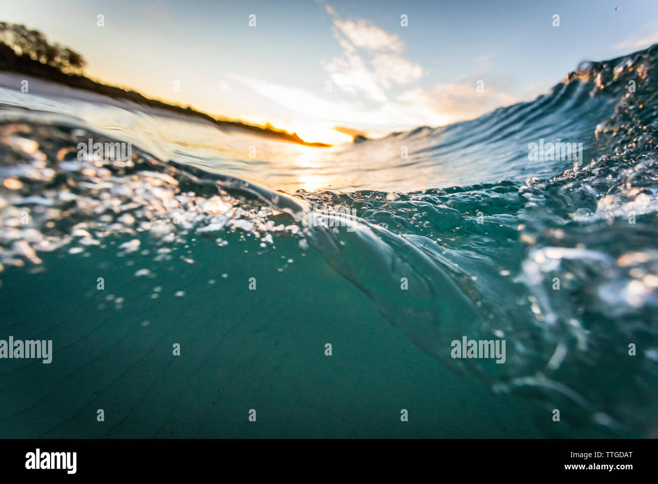 Wave at sunrise Stock Photo - Alamy