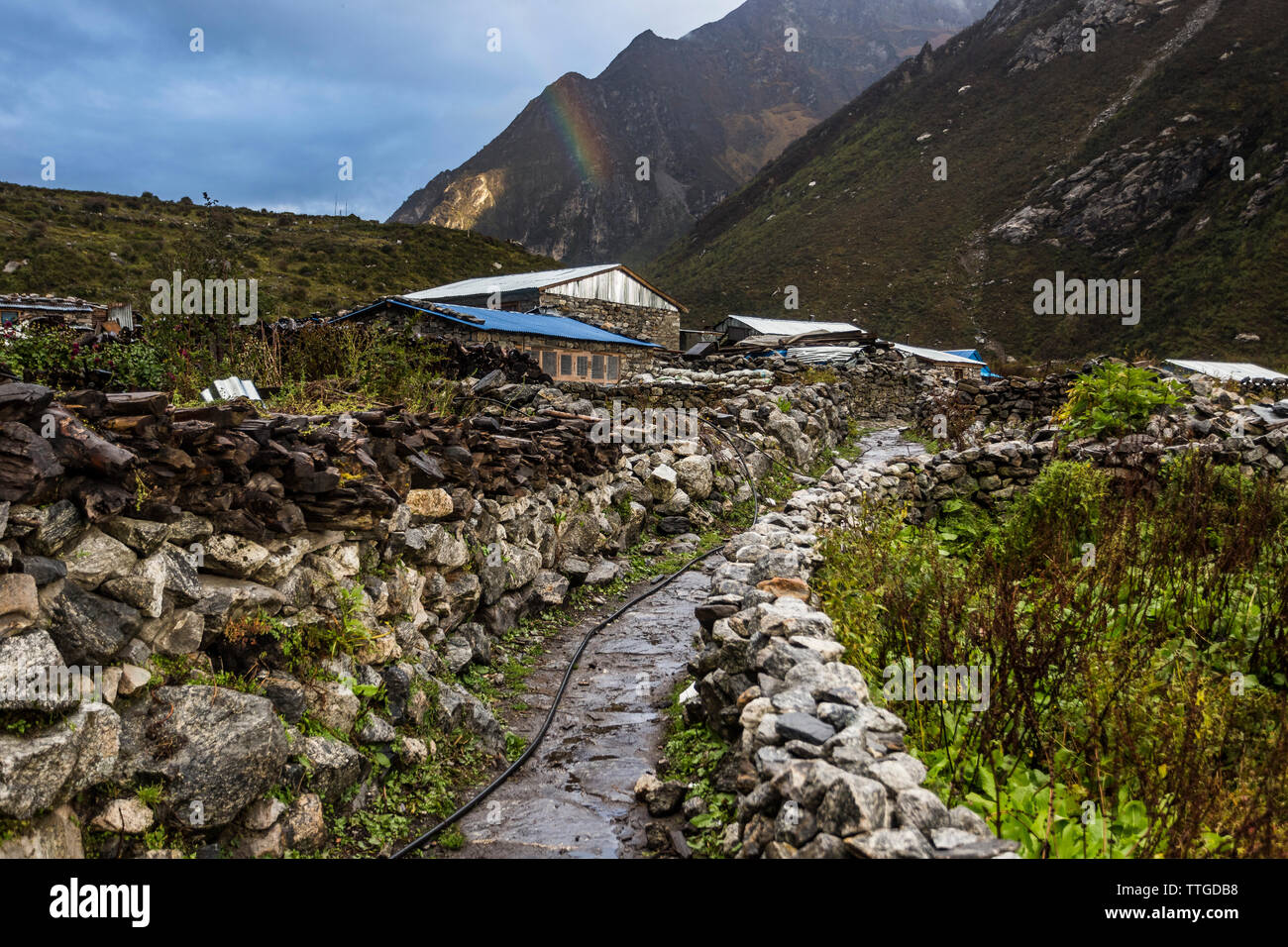 View of Mountain village and stone walls with Rainbow Stock Photo - Alamy