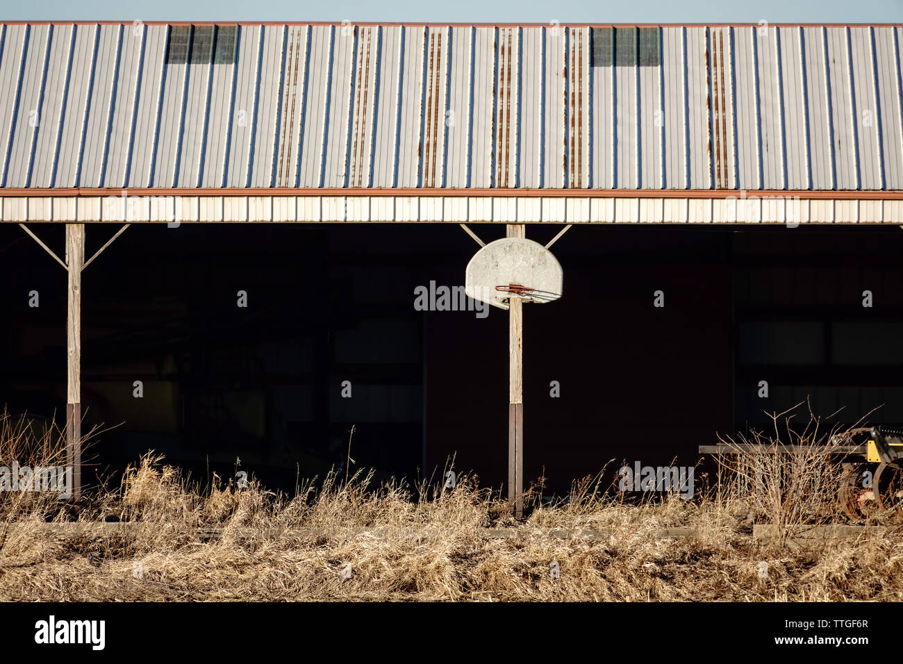 Basketball hoop and backboard on exterior of shed on a Midwestern farm