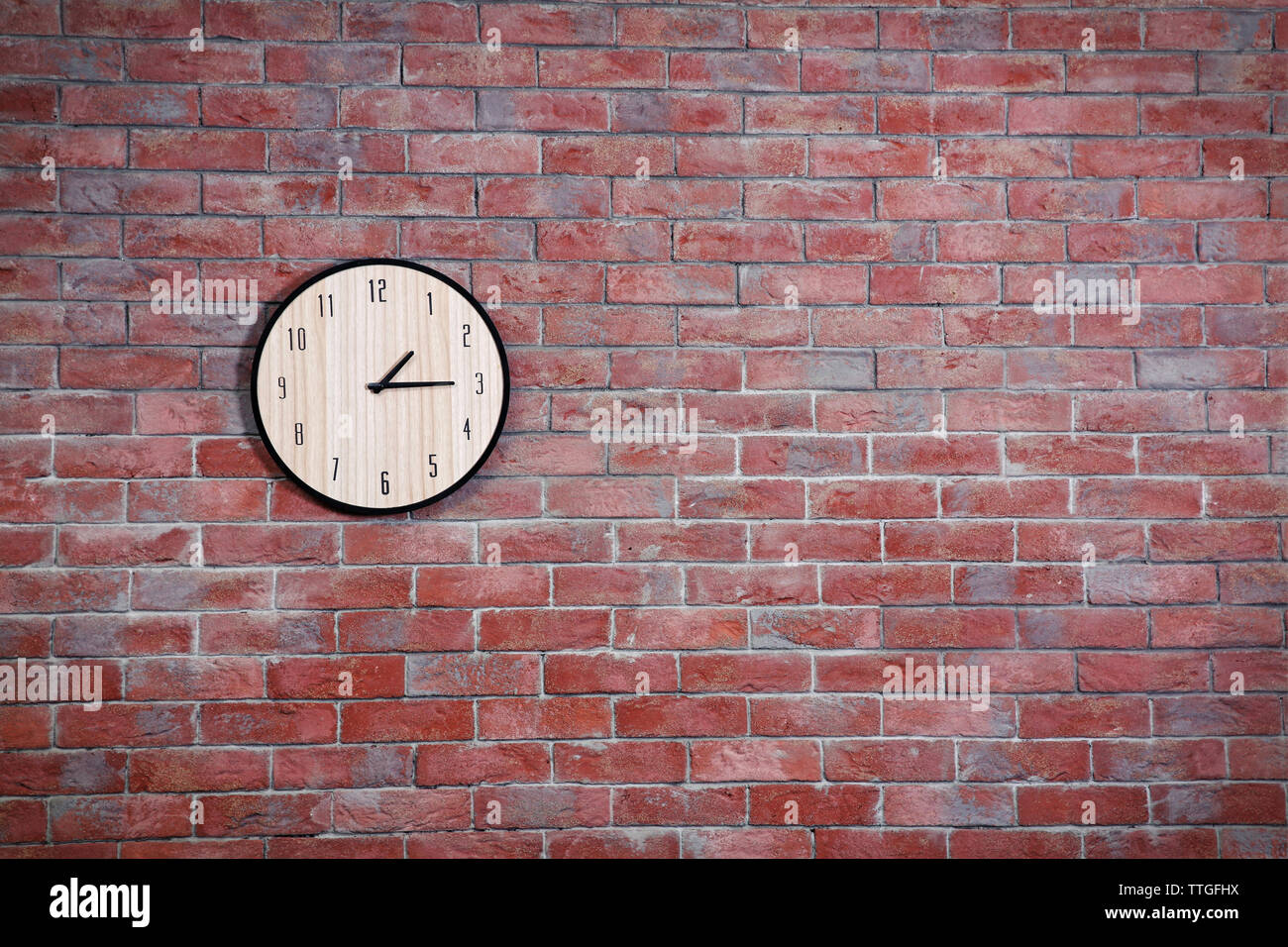 Clock on brick wall background Stock Photo Alamy