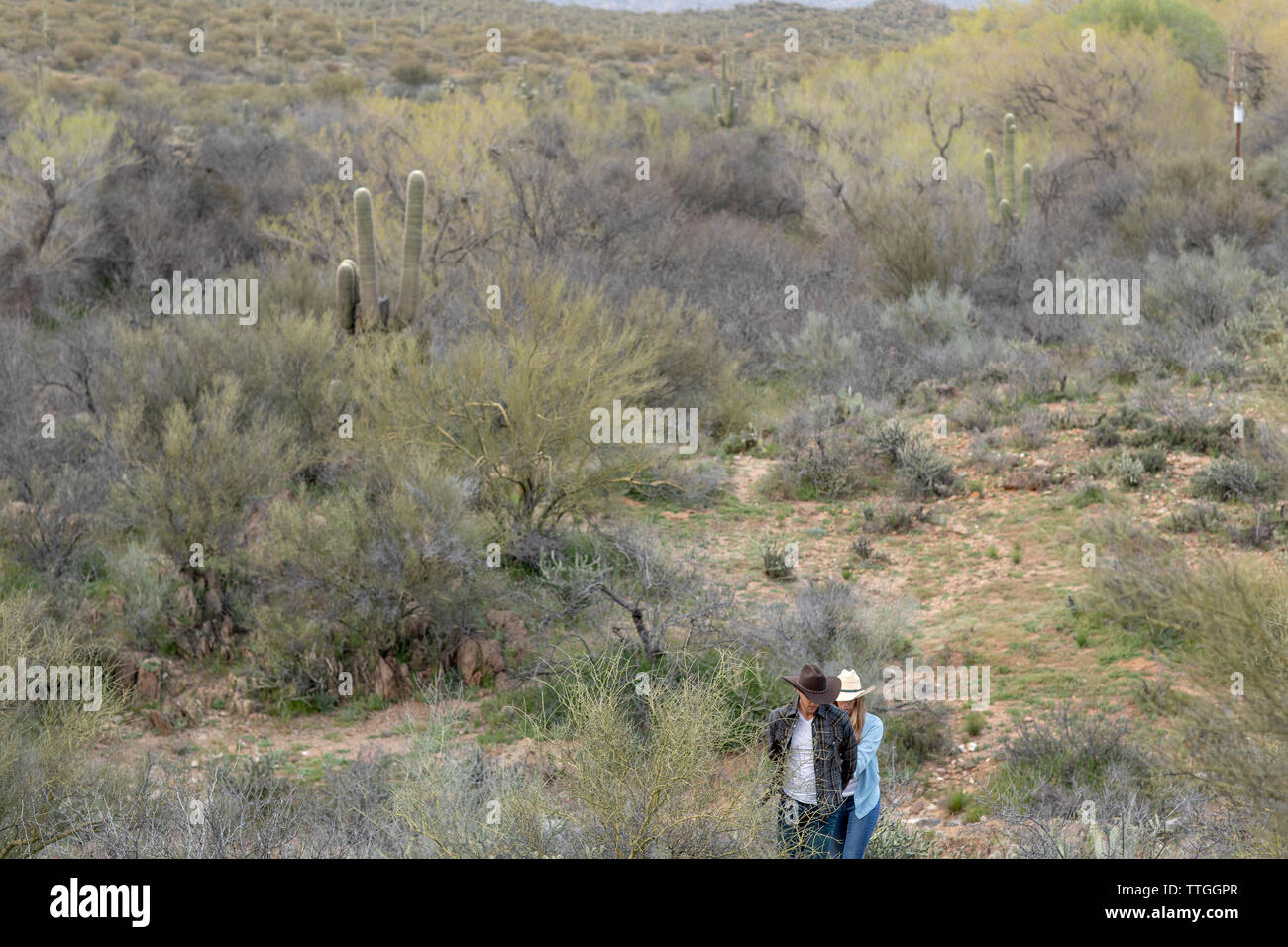 Western wear young married couple on desert ranch Stock Photo