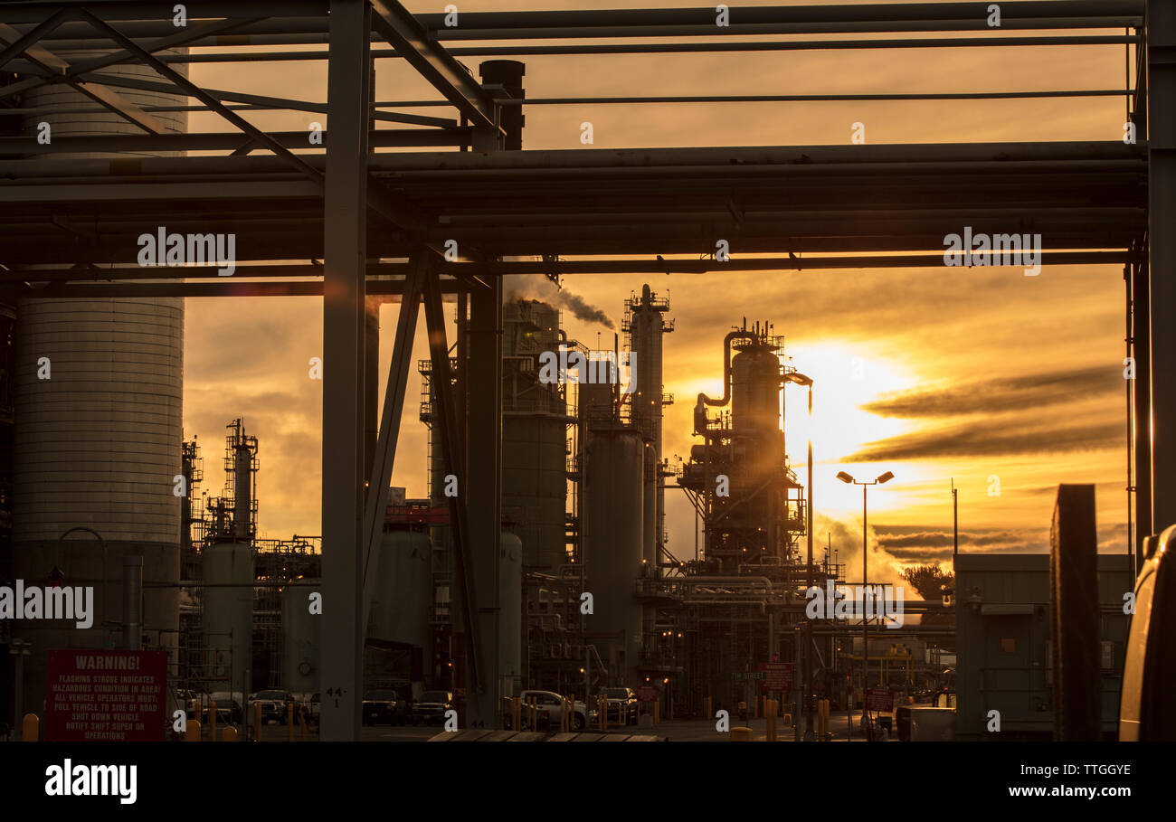 Factory against cloudy sky during sunset Stock Photo