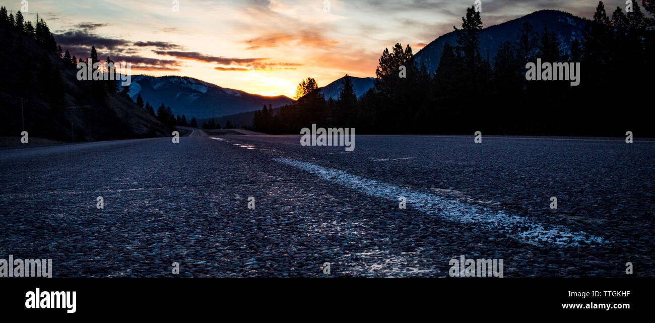 Sunrise along an open road (interstate 90) west of Missoula, Montana. Stock Photo