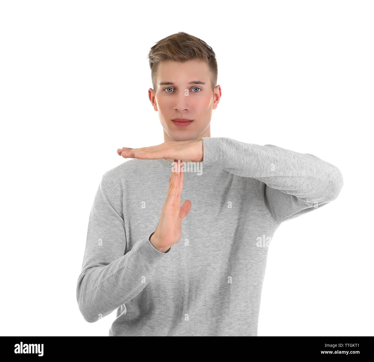 Young handsome man shows timeout, isolated on white Stock Photo