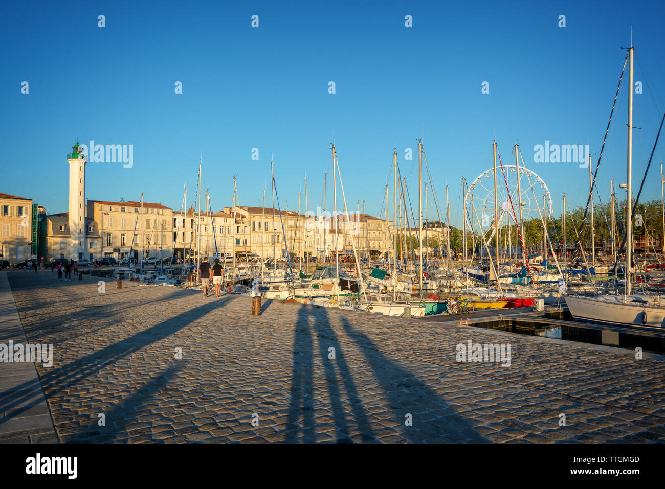 Sailboats in the old harbor of La Rochelle, France at sunset Stock Photo